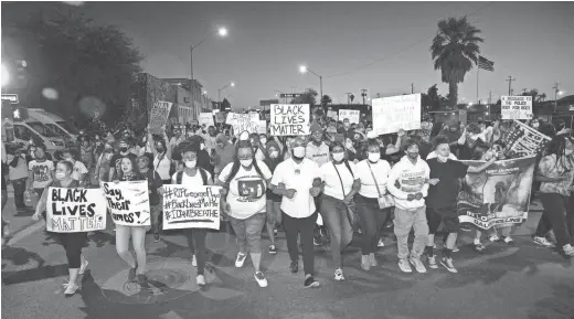  ?? ROB SCHUMACHER/THE REPUBLIC ?? The Rev. Jarrett Maupin, center, wearing black pants, leads hundreds of protesters on May 28 in downtown Phoenix.