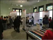  ?? RICHARD PAYERCHIN — THE MORNING JOURNAL ?? Guests mingle among the new displays for Latino Lorain History Project, which has an exhibit centered around Vine Avenue, during the preview part on Sept. 9.