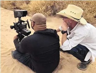  ?? COURTESY OF BOHDI RADER ?? Adam S. Ford with Dan Mathis on set in New Mexico.