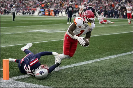  ?? CHARLES KRUPA — THE ASSOCIATED PRESS ?? Kansas City Chiefs running back Jerick Mckinnon enters the end zone for a touchdown as New England Patriots linebacker Marte Mapu tries to defend during the first half Sunday in Foxborough, Mass.