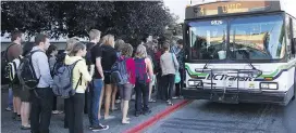  ??  ?? Passengers line up for a bus heading for the University of Victoria, one of the region’s busiest routes. The province has boosted funding to B.C. Transit in an attempt to cut wait times.