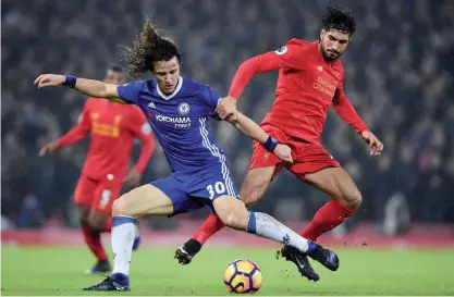  ??  ?? LIVERPOOL: Chelsea’s Brazilian defender David Luiz (L) vies with Liverpool’s German midfielder Emre Can during the English Premier League football match between Liverpool and Chelsea at Anfield in Liverpool, north west England on Tuesday. — AFP