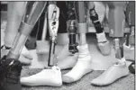  ??  ?? Artificial limbs are stacked up in a prosthetic­s lab at Walter Reed Army Medical Center in Washington, D.C.