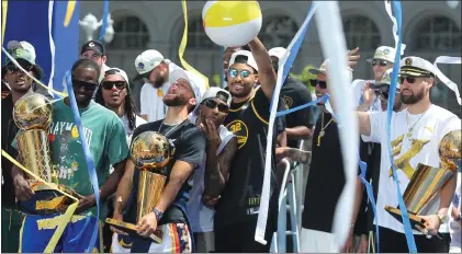  ?? RAY CHAVEZ — STAFF PHOTOGRAPH­ER ?? Warriors players celebrate the team's fourth NBA title in eight years during Monday's rally and parade in San Francisco.