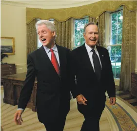  ?? Doug Mills / New York Times 2005 ?? Former Presidents Bill Clinton and George H.W. Bush returned to the Oval Office to meet with President George W. Bush about Hurricane Katrina relief.