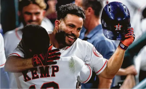  ?? Brett Coomer / Houston Chronicle ?? Left fielder Tony Kemp gives Jose Altuve a warm welcome after completing the Astros’ three successive homers in the sixth inning with his second shot of the game.