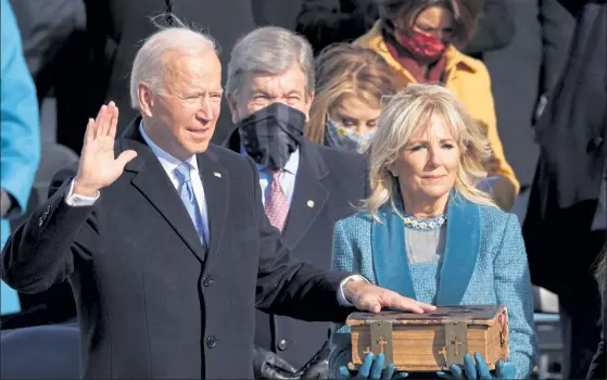  ?? ALEX WONG / GETTY IMAGES ?? Joe Biden is sworn in as the 46th president during his inaugurati­on on the west front of the U.S. Capitol on Wednesday in Washington.