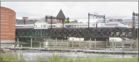  ?? Alex von Kleydorff / Hearst Connecticu­t Media ?? At top, the latest bridge rendering. Above, an Acela train crosses the Walk Bridge over the Norwalk River at The Maritime Aquarium and the IMAX Theater on Monday in Norwalk.