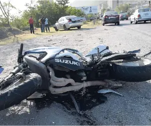  ?? GLADSTONE TAYLOR/ PHOTOGRAPH­ER ?? This bike on the Norman Manley Boulevard last Friday marked the scene of yet another motor vehicle accident. Luckily, there were no fatalities from this crash.