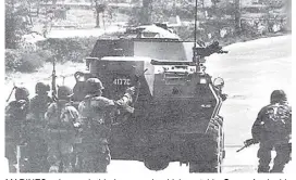  ?? ?? MARines advance behind armored vehicle outside camp Aguinaldo clossing in on rebel units.