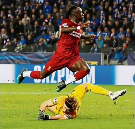  ??  ?? Easy does it: sadio mane jumping over Genk goalkeeper to score for Liverpool in their Champions League match on oct 23. — reuters