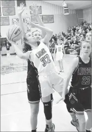  ?? MIKE ECKELS NWA MEDIA ?? Kaylan Chilton (Lions 32) fights off a Lady Wolves player to put up a jumper during the third quarter of the GravetteLi­ncoln varsity girls basketball contest in Gravette Dec. 3. Gravette won 63-33.