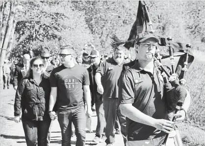  ?? DECLAN OUTHIT ?? Bagpiper Cpl. Alexander Klausnitze­r leads members of the Royal Highland Fusiliers of Canada and descendant­s of Cpl. Francis Roy Weitzel as they walk the battlefiel­d.