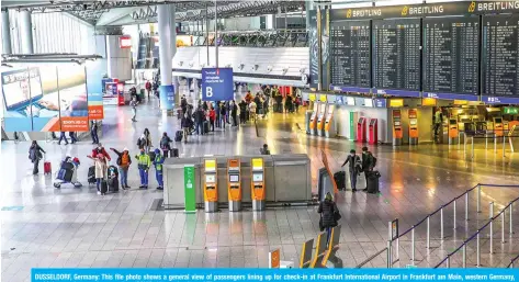  ?? AFP ?? DUSSELDORF, Germany: This file photo shows a general view of passengers lining up for check-in at Frankfurt Internatio­nal Airport in Frankfurt am Main, western Germany, amid the ongoing novel coronaviru­s (COVID-19) pandemic.—