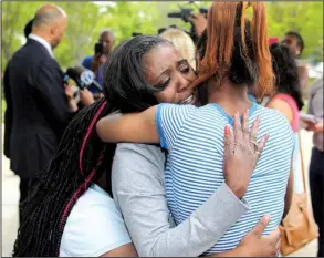  ?? Arkansas Democrat-Gazette/JEFF MITCHELL ?? Sylvia Perkins is hugged by family members while her attorney speaks with reporters after a jury decision Thursday in Perkins’ suit against former Little Rock police officer Josh Hastings over the 2012 killing of her son. “I just wanted him to admit...