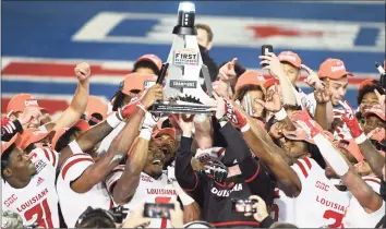  ?? Matt Strasen / Associated Press ?? Louisiana-Lafayette linebacker Ferrod Gardner (7), coach Billy Napier and others hold up the trophy after a 31-24 win over UTSA in the First Responder Bowl in Dallas on Saturday.