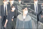  ?? EUGENE HOSHIKO — THE ASSOCIATED PRESS ?? Japan’s former Princess Mako, the elder daughter of Crown Prince Akishino, and her husband Kei Komuro walk to board an airplane to New York Sunday at Tokyo Internatio­nal Airport in Tokyo.