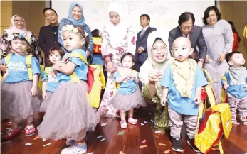  ??  ?? Fatimah shows her thumbs-up to the camera as she joins the little children and their parents on-stage after the launch of SEB’s ‘Little Power Genius Childcare Centre. — Photo by Chimon Upon