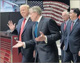  ?? ASSOCIATED PRESS] [SUSAN WALSH/THE ?? President Donald Trump tours the headquarte­rs of Snap-on Inc. in Kenosha, Wis., with Chief Executive Officer Nicholas T. Pinchuk, center, followed by Sen. Ron Johnson, R-Wis., and Gov. Scott Walker. Behind them is an American flag made out of wrenches.