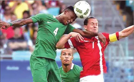  ??  ?? Abdullahi Shehu (left) in aerial battle with a Danish forward during the Rio 2016 Olympic Games men’s football tournament in Brazil