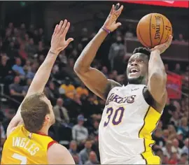  ?? Rick Bowmer Associated Press ?? THE LAKERS’ Julius Randle shoots over Jazz forward Joe Ingles during Tuesday night’s game. Randle finshed with 12 points, 12 rebounds and nine assists.