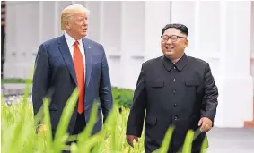  ?? EVAN VUCCI/ASSOCIATED PRESS ?? U.S. President Donald Trump and North Korea leader Kim Jong Un walk from their lunch at the Capella resort on Sentosa Island in Singapore on Tuesday.