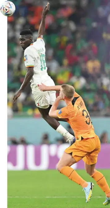  ?? — AFP ?? Senegal forward Ismaila Sarr (L) fights for the ball with Netherland­s’ defender Matthijs De Ligt during the Qatar 2022 World Cup Group A match at the Al Thumama Stadium in Doha.