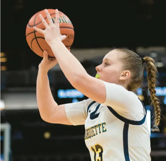  ?? MICHAEL GARD/POST-TRIBUNE PHOTOS ?? TOP: Marquette’s Marissa Pleasant moves the ball during the Class 1A state championsh­ip game against Lanesville at Gainbridge Fieldhouse in Indianapol­is on Saturday ABOVE: Pleasant takes a shot game against Lanesville.