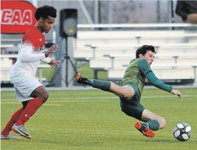  ?? CLIFFORD SKARSTEDT EXAMINER ?? Fleming Knights’ Josh Herter is sent flying through the air against Fanshawe Falcons’ Malachi Morris.