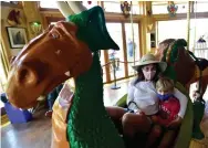  ?? Jeremy Papasso, Daily Camera ?? Jan Karp and her grandson Hayes ride the Carousel of Happiness on June 12 in Nederland. A ride is only $2.