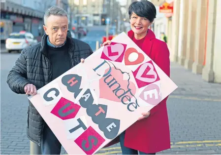  ??  ?? Rory Malone and Jayne Kelly on Lochee High Street with the card for the council.