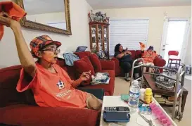  ?? Steve Gonzales / Houston Chronicle ?? Eugenia Rios — with Darlene Lang, center, and Ardie Rocha — cheers for the Astros in Game 5 of the American League Championsh­ip Series. Rios predicts the Astros will win the next two games at home.