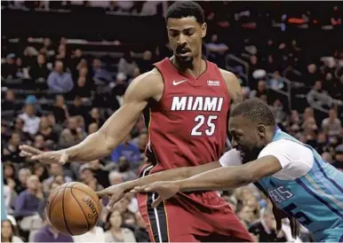  ?? CHUCK BURTON/AP ?? The Hornets’ Kemba Walker and the Heat’s Jordan Mickey (25) chase the ball during their game in Charlotte, N.C., on Friday.