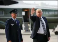  ?? PABLO MARTINEZ MONSIVAIS — THE ASSOCIATED PRESS ?? President Donald Trump waves to members of the media after arriving on Air Force One, Friday at Andrews Air Force Base in Md. Watching is Air Force Col. Samuel Chesnut.