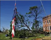  ?? PEDRO PORTAL/MIAMI HERALD ?? A U.S. flag hangs from a bent pole in front of a school in Panama City, Fla., the day after Hurricane Michael slammed the Florida Panhandle.