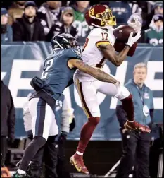  ?? Tribune News Service ?? Washington Football Team WR Terry Mclaurin (17) makes a catch as philadelph­ia Eagles CB darius Slay (2) defends at Lincoln Financial Field, Tuesday, dec. 21, 2021.