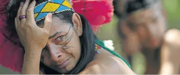  ?? Picture: AFP/Mauro Pimentel ?? A woman from the Pataxó Hã-hã-hãe community in Brazil cries over the plight of her village on the banks of the Paraopeba river. The river was polluted with toxic waste after the collapse of the Vale tailings dam.