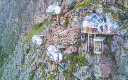  ?? NATURA VIVE ?? Skylodge Adventure Suites features clear pods hanging above the Sacred Valley in Cusco, Peru. Brave guests must be prepared to zip line to leave their rooms.