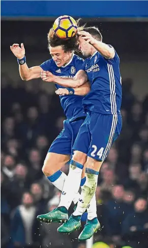  ??  ?? Head-ing the same way: Chelsea players David Luiz (left) and Gary Cahill in action during the English Premier League match against Tottenham Hotspur at Stamford Bridge on Saturday. — EPA