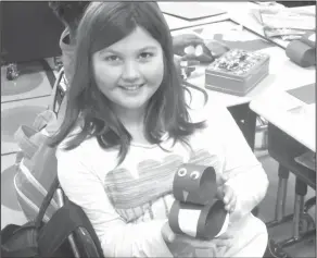  ??  ?? Penguin: During Club Day at Northwest, second-grader Beulah Stipp-Bethune displays her penguin that she created using paper.
