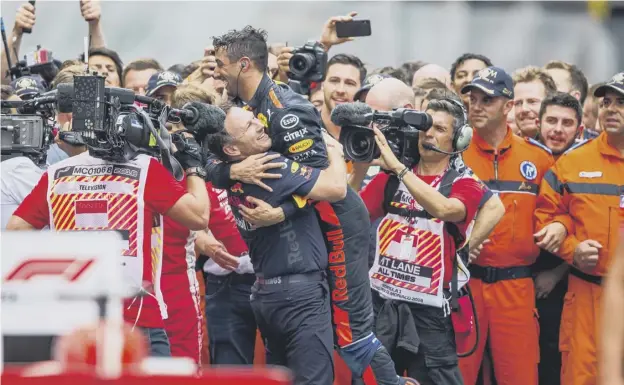  ?? PICTURE: PETER J FOX/GETTY IMAGES ?? 0 Daniel Ricciardo celebrates with Red Bull’s team principal Christian Horner after his victory in Monaco yesterday.