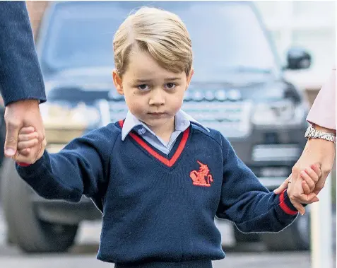  ??  ?? Big step: Prince George looks anxious as he arrives for his first day, holding the hands of his father and Helen Haslem, head of the lower school at Thomas’s Battersea