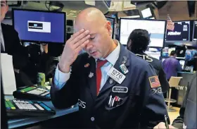  ?? [AP PHOTO] ?? Specialist Mario Picone on Wednesday works on the floor of the New York Stock Exchange.