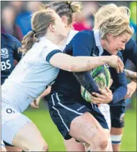  ?? SNS Group. ?? Hannah Gallagher challenges Louise Dalgliesh as the Scots struggle to get into the game.