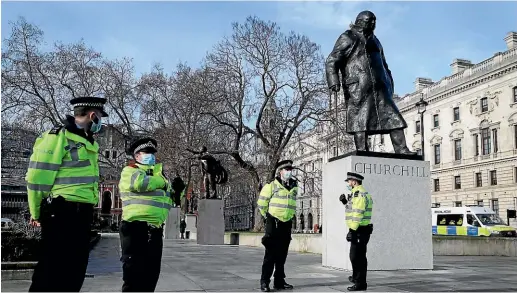  ?? AP ?? Police officers patrol near the Winston Churchill statue opposite Parliament in London yesterday during England’s third national lockdown.