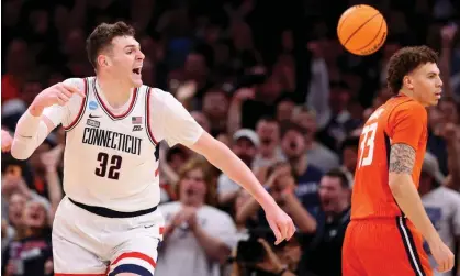  ?? ?? Donovan Clingan of the Connecticu­t Huskies celebrates a basket against the Illinois Fighting Illini during the second half of Saturday’s Elite Eight showdown in Boston. Photograph: Michael Reaves/Getty Images