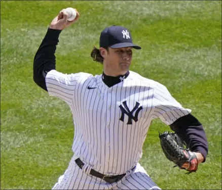  ?? KATHY WILLENS - THE ASSOCIATED PRESS ?? New York Yankees starting pitcher Gerrit Cole (45) winds up on a pitch during the first inning of a baseball game against the Tampa Bay Rays, Sunday, April 18, 2021, at Yankee Stadium in New York.