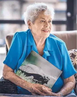  ?? ROBERTO E. ROSALES/JOURNAL ?? Millie Tjeltweed, a resident of Manzano del Sol Village, holds a picture of Diablo, a desert tortoise she gave to the senior living community seven years ago. Diablo, thought to be about 115 years old, has been missing for nearly a week.