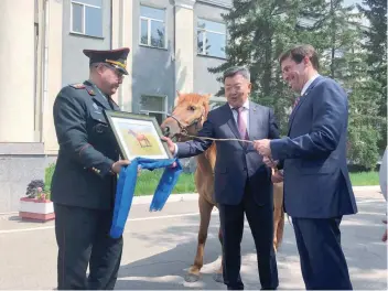  ?? — Reuters ?? US Secretary of Defence Mark Esper (R) is gifted a horse in Ulan Bator on Thursday.