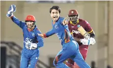  ?? CONTRIBUTE­D ?? Afghanista­n’s Rashid Khan (centre) celebrates after he trapped West Indies’ Ashley Nurse leg before wicket in the first one-day internatio­nal at Darren Sammy National Cricket Stadium, Gros Islet, St Lucia, on Friday night.